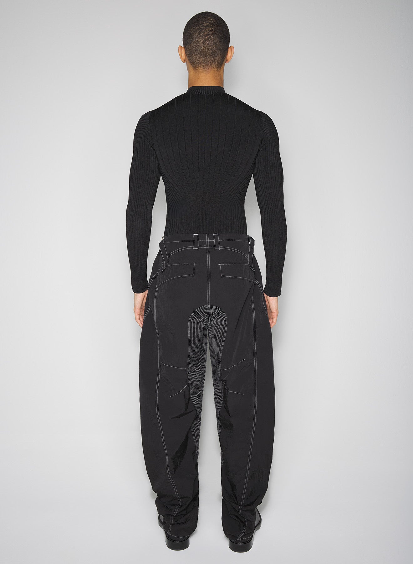 black stitched parachute pants
