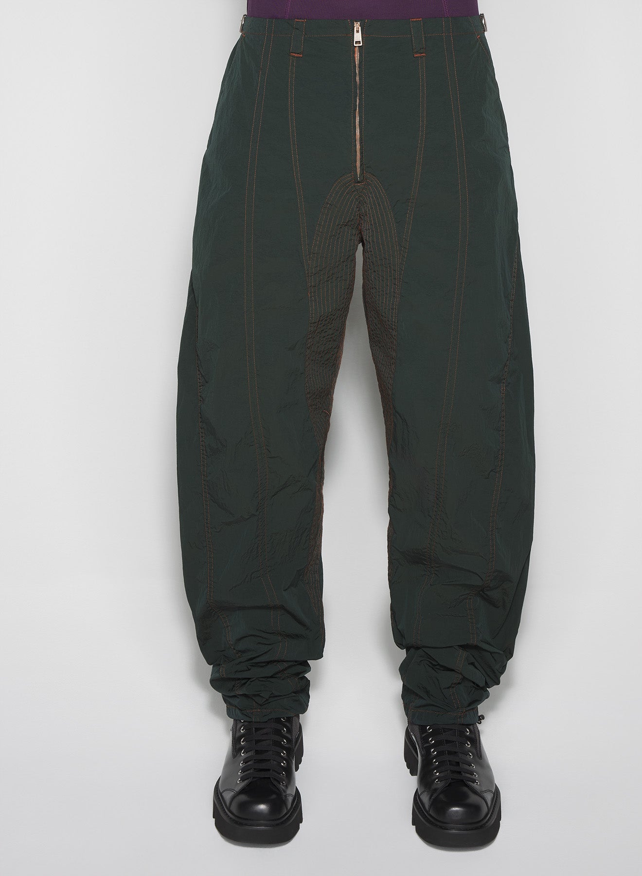 green stitched parachute pants