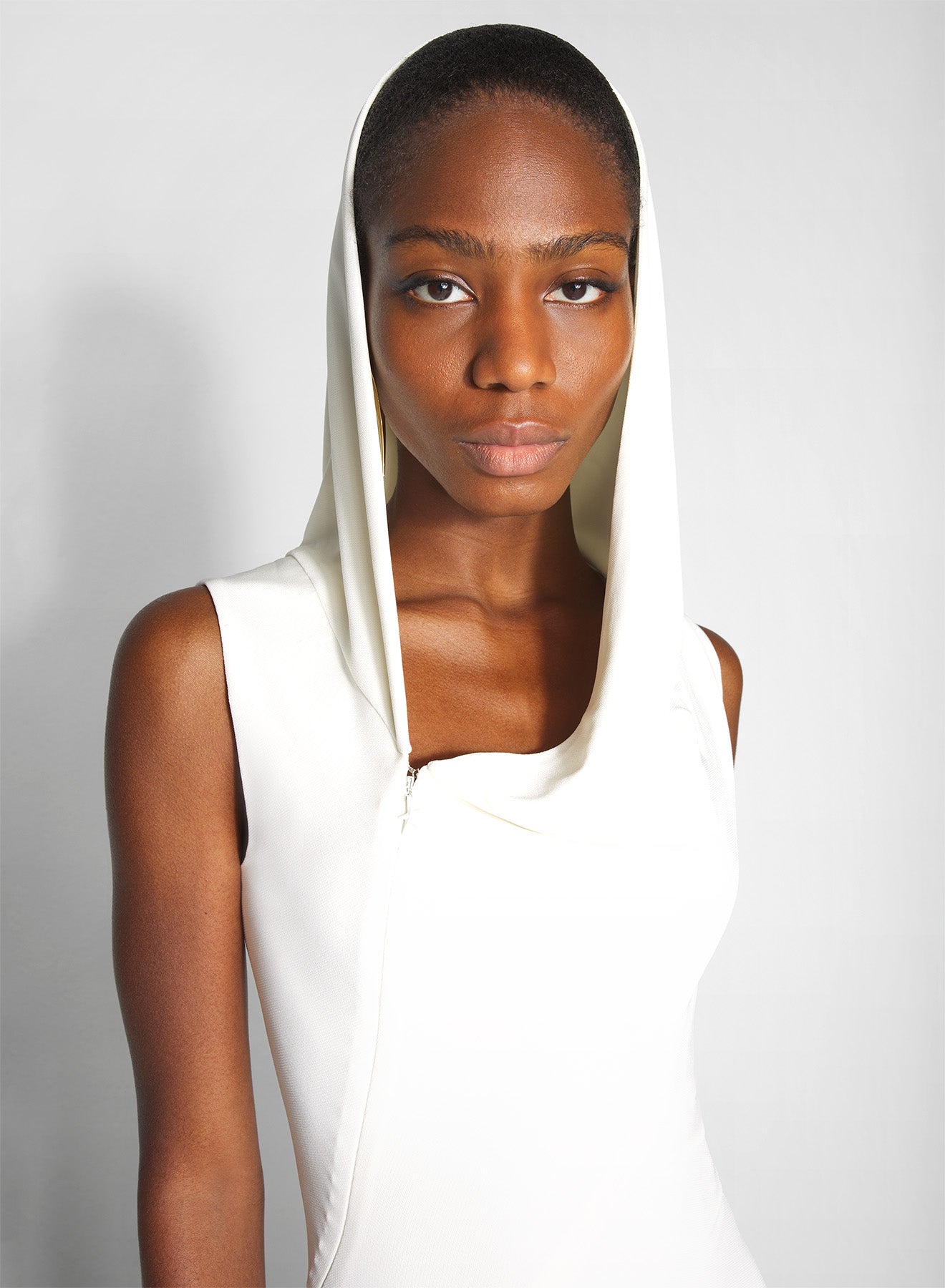 white hooded sleeveless gown
