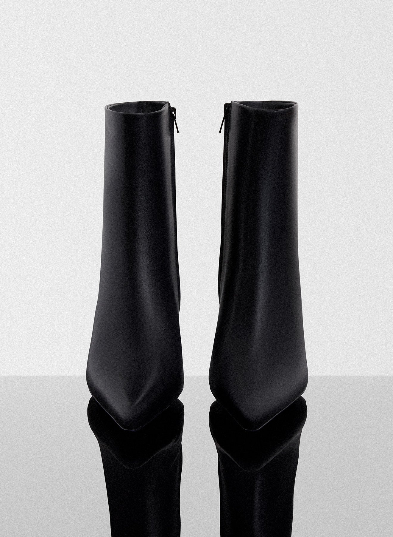 black curved heel ankle boots