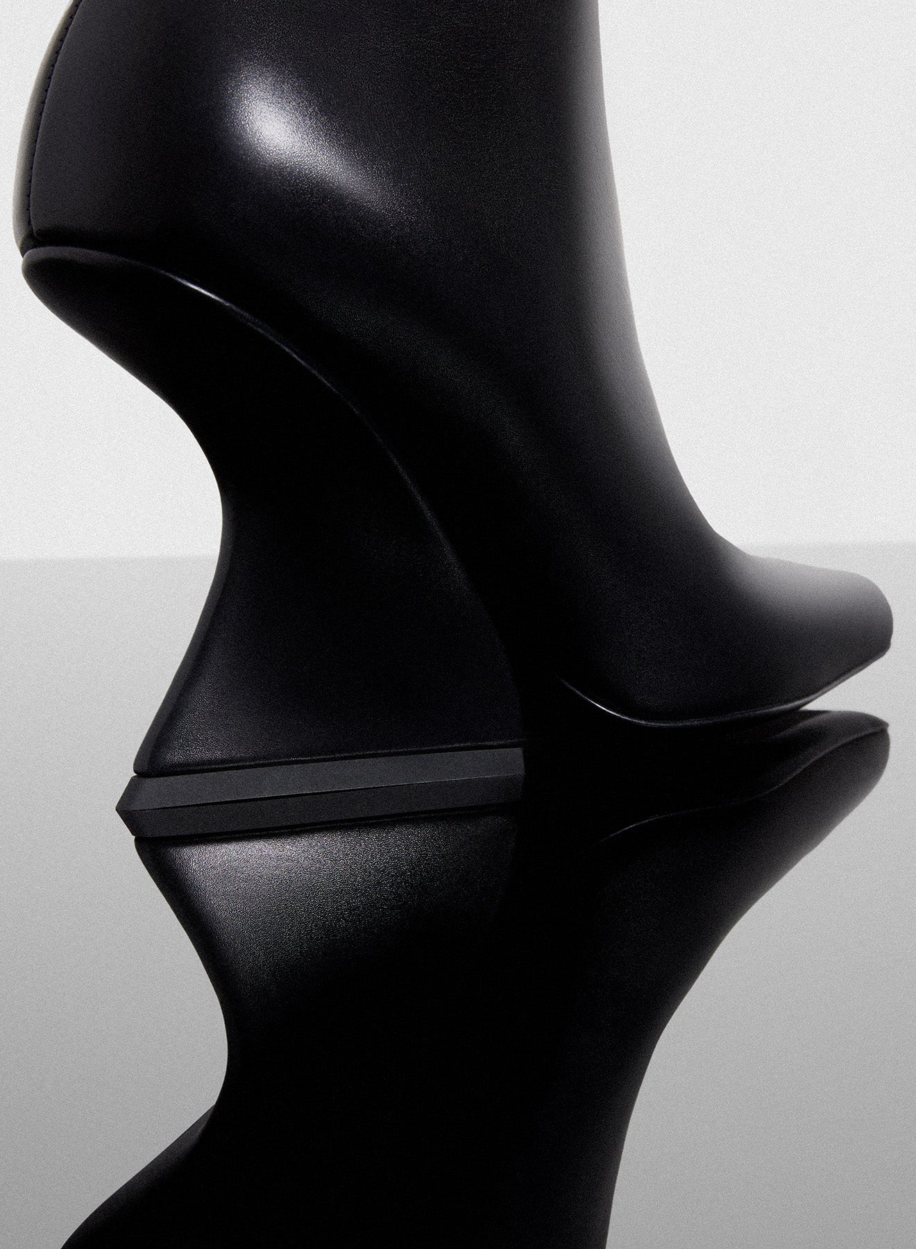 black curved heel ankle boots