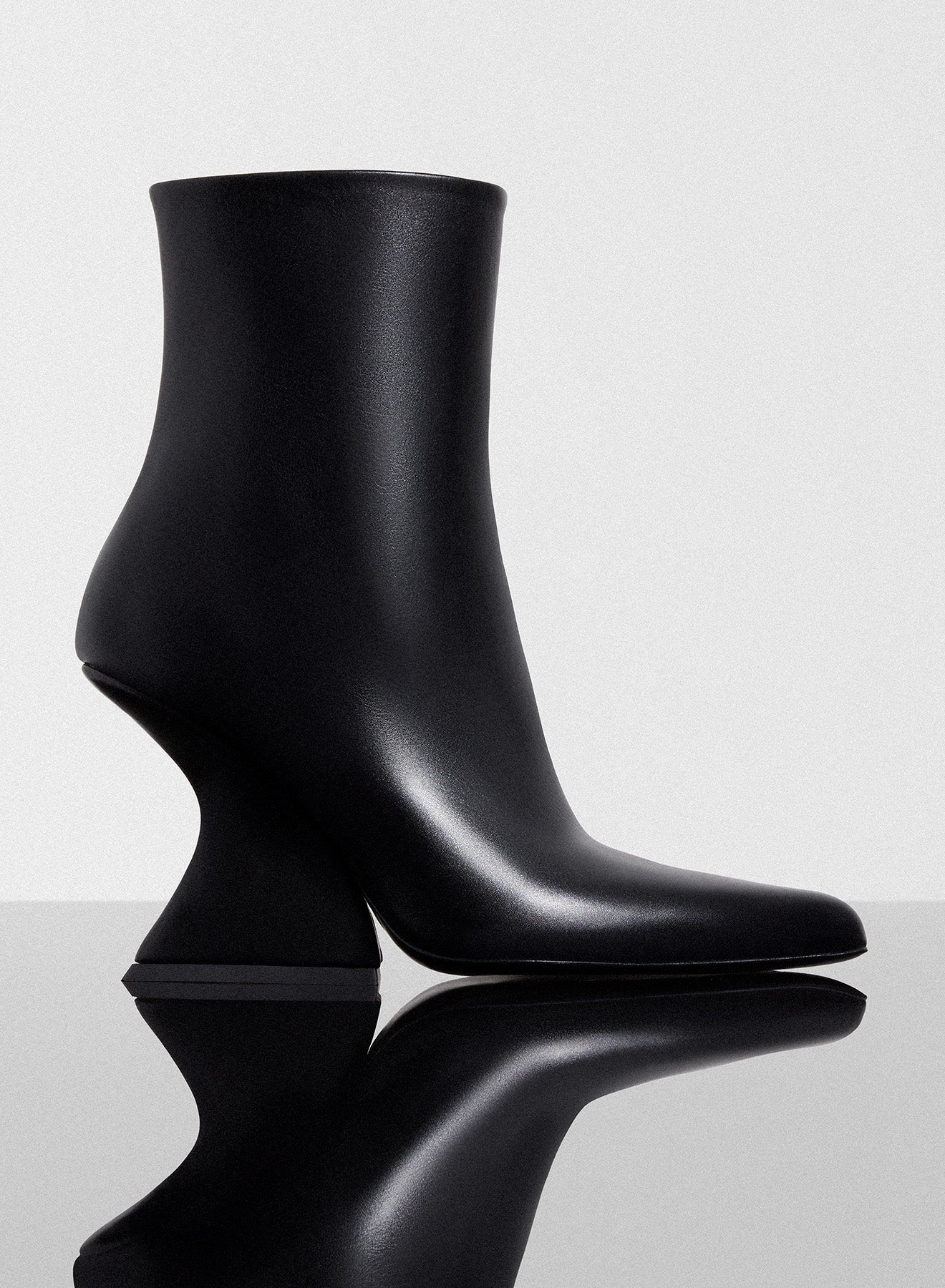 black curved heel ankle boots