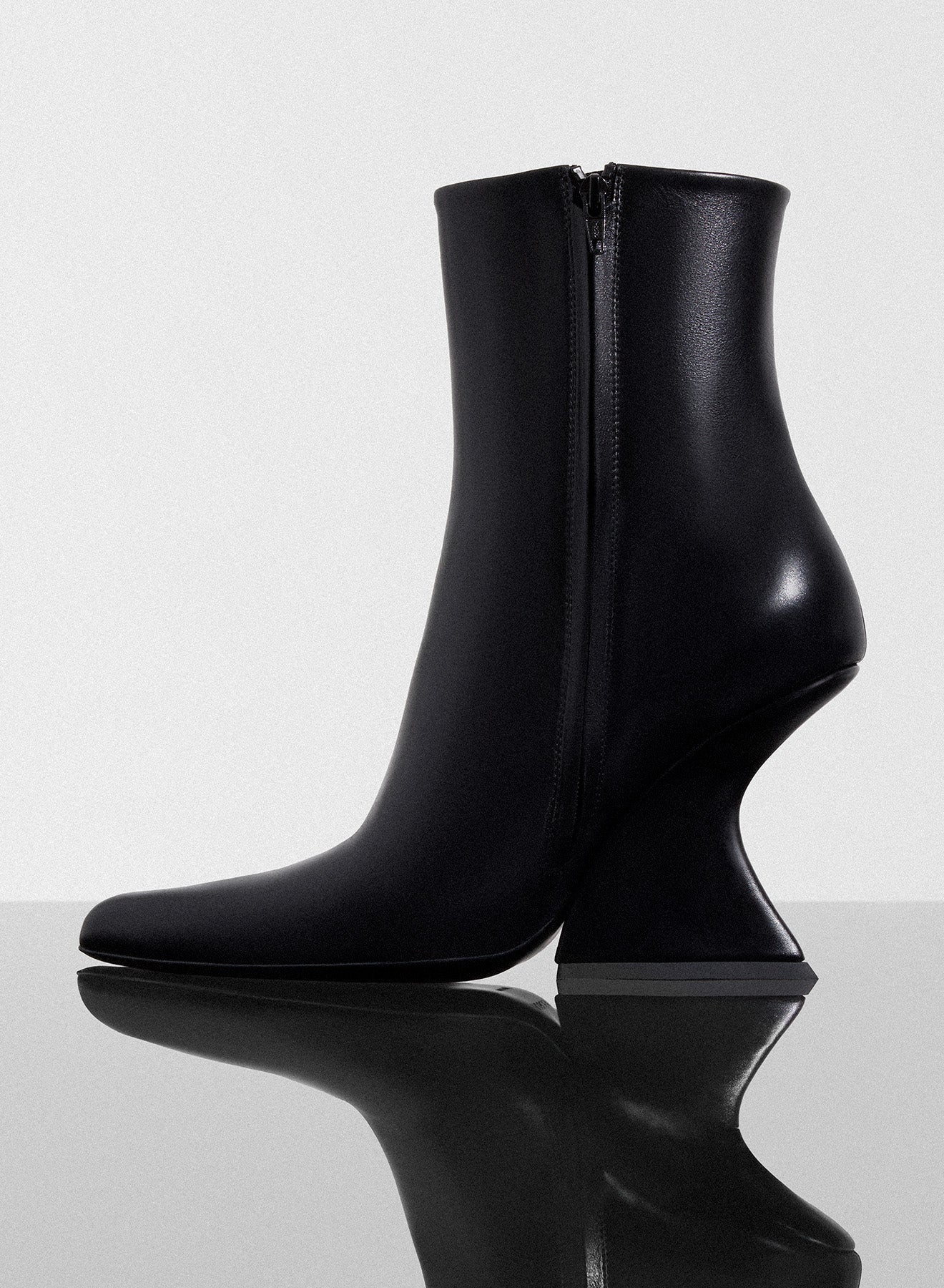 black curved heel ankle boots