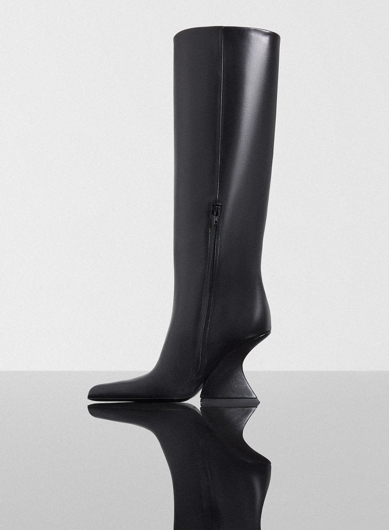 black curved heel knee-high boots