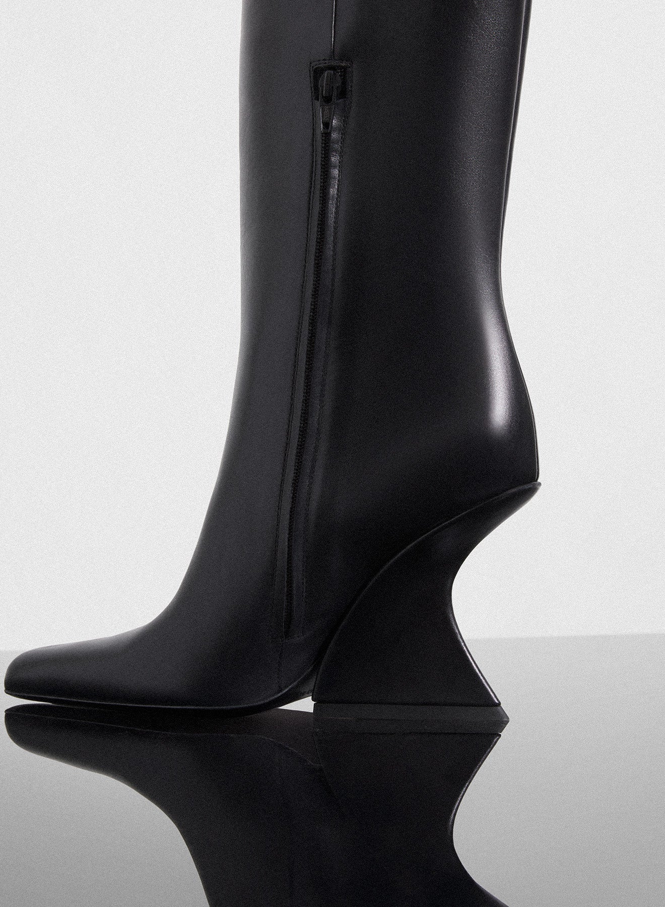 black curved heel knee-high boots