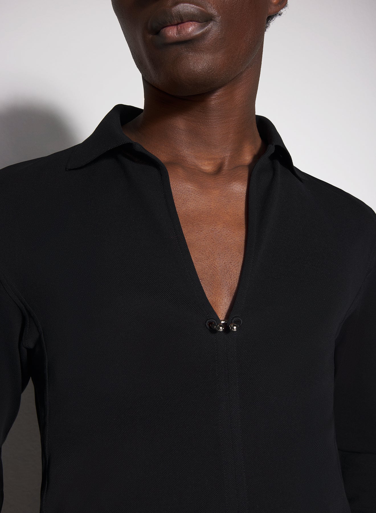 black pierced polo