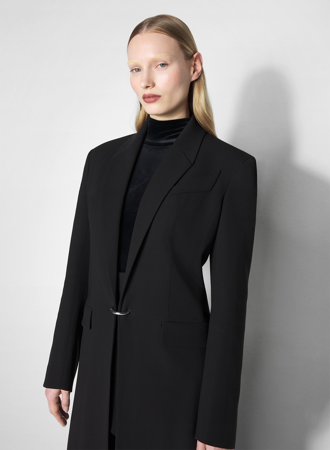 black pierced tailored coat