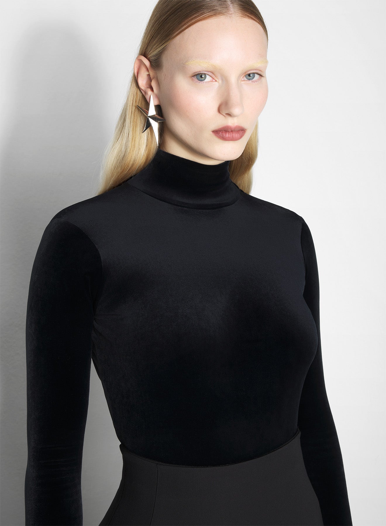 black open-back velvet bodysuit