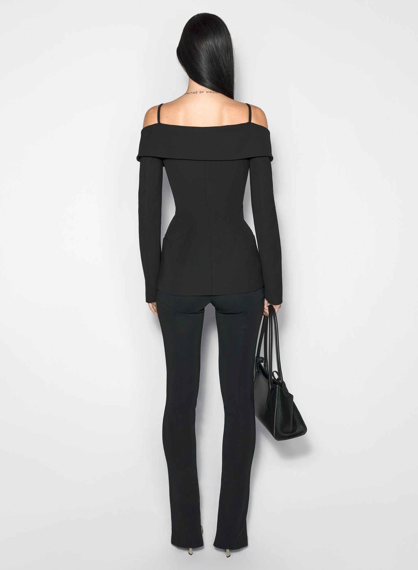 black sculptural off-shoulder jacket