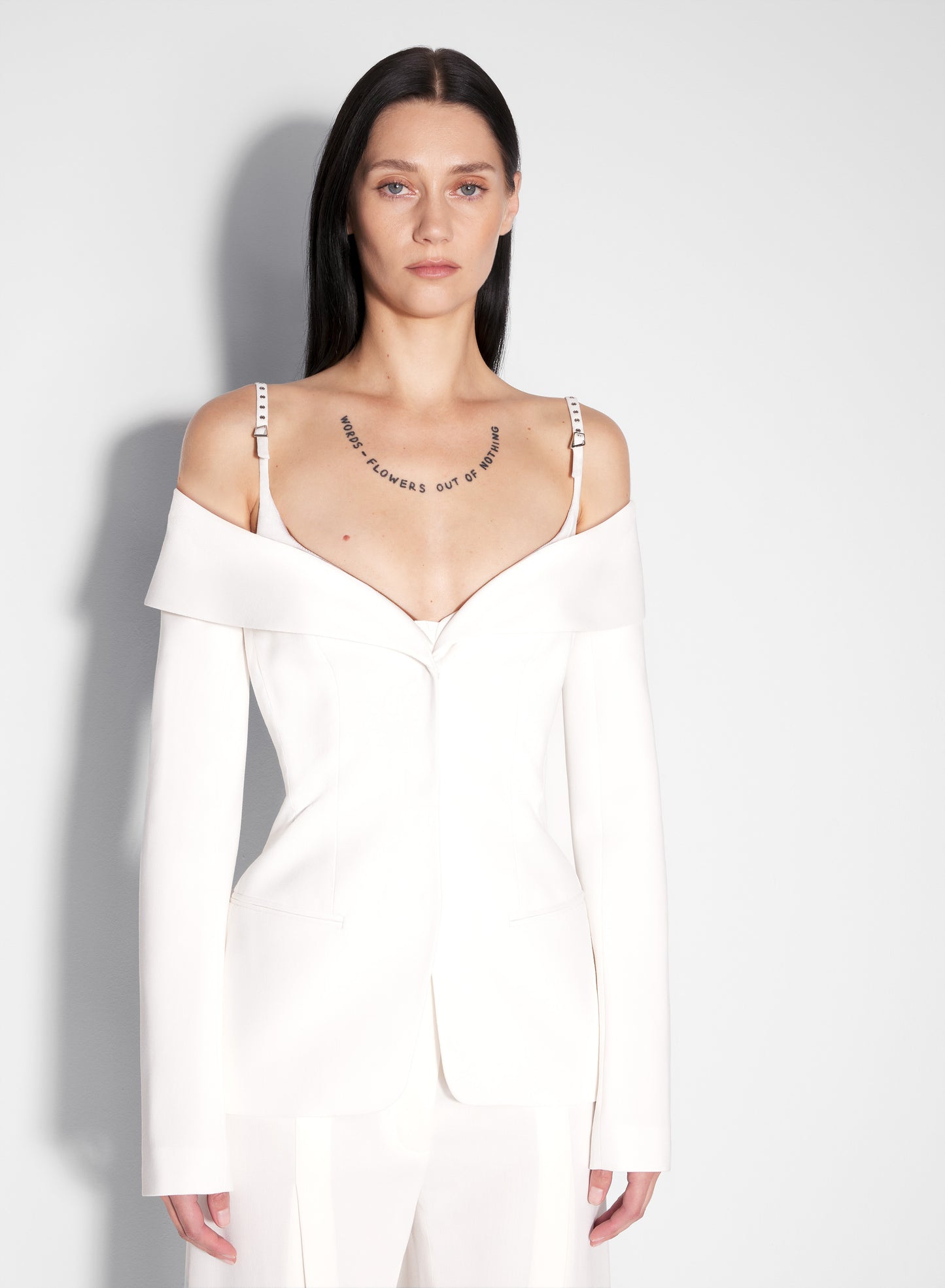 white sculptural off-shoulder jacket