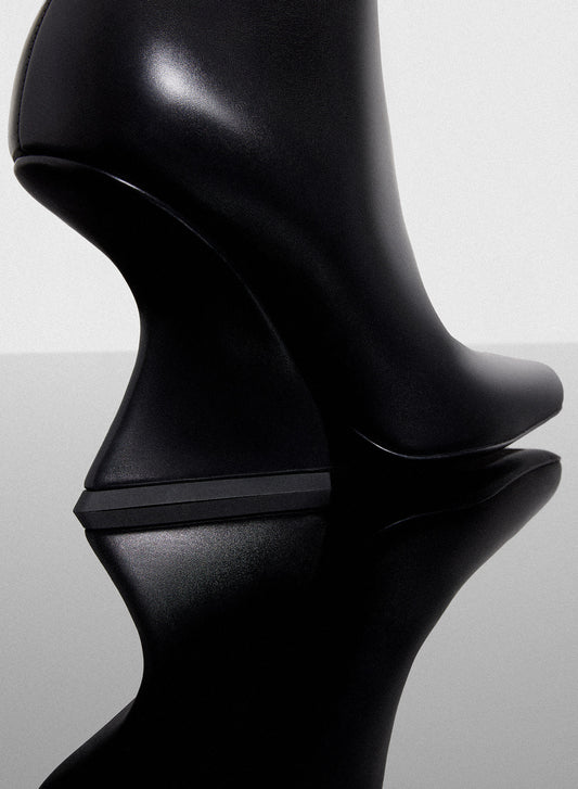 black curved heel ankle boots
